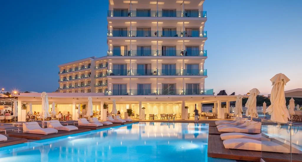 Blue Ivy Hotel & Suites, Protaras — hotel and pool at dusk